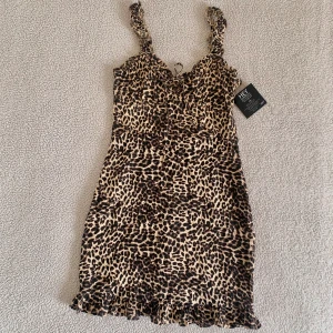Nelly mini klänning i viskos leopardmönster - Superfin klänning från Nelly i viskos med leopardmönster. Ny med tags kvar, utan anmärkningar. Stretchig och bekväm passform. 