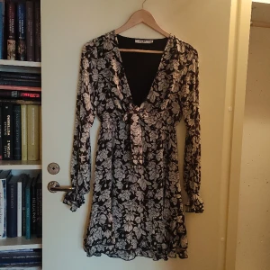 Storblommig klänning med knytdetalj - Storblommig sommarklänning med knytdetalj. Volang nedtill och i ärmen, svalt och skönt tyg. Provad, men annars oanvänd. Kan möta upp i lundz annars står köpare för frakten 🌸