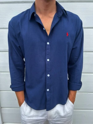 Ralph Lauren Linneskjorta – Strl S – Mycket fint skick - Säljer en riktigt snygg linneskjorta från Ralph Lauren i mycket fint skick. Den är endast använd ett fåtal gånger och har därför inga tecken på användning.  Skjortan är tillverkad i ett tunt och luftigt linnematerial som passar perfekt under varmare dagar. Storleken är S, men den passar även dig som vanligtvis använder XS beroende på önskad passform.  Hör gärna av dig om du har några frågor eller vill se fler bilder!