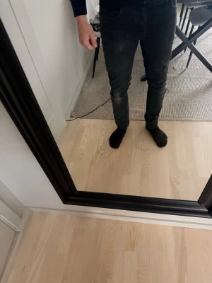 Nudie Jeans svarta - Säljer ett par svarta nudie jeans med slitningar. Jeansen har en klassisk femficksdesign och normal midja. Jeansen har en smal passform hela vägen ner och är perfekta för dig som gillar en stilren och enkel look.