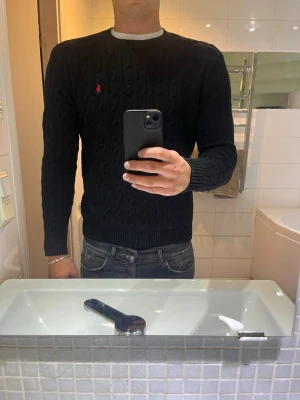 Ralph Lauren Stickad Tröja - Säljer denna feta kabelstickade Ralph Lauren tröjan som är perfekt nu till höst och vinter. Tröjan är i bra skick(se bilder)✅ Hör av dig vid funderingar💯