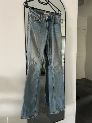 Blåa lågmidjade jeans - Lågmidjade, utsvängda blåa jeans från gina tricot i bra skick. 💕