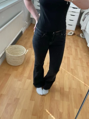 Svarta bootcut jeans med stretch - Snygga svarta bootcut jeans med klassisk femficksdesign och diskreta sömmar. Jeansen har en något utsvängd passform nertill och är tillverkade i stretchigt denimtyg för extra komfort.