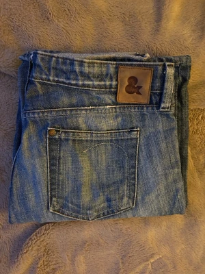 Vintage jeans - PRIS GÅR ATT DISKUTERA. Snygga blå vintage jeans från HM med klassisk femficksdesign och läderpatch bak i midjan. Jeansen har raka ben och är tillverkade i slitstark denim. Perfekta för en avslappnad och trendig stil. Köpta mellan 1985-2005 så därav går dom inte längre att få tag på💗