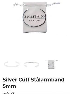 Silverfärgat cuff armband Zwietz & Co. Stålarmband - Snyggt och stilrent cuff armband i silverfärgat stål från Zwietz & Co. Armbandet är 5 mm brett och har en öppen design som gör det enkelt att ta på och av. Märkets logga är ingraverad på framsidan för en clean och modern look.
