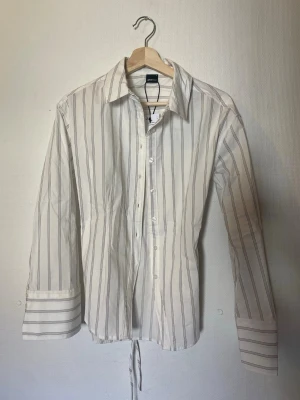 shaped blouse Gina tricot brun och vit randig - Säljer denna jätte fina blus från Gina tricot då den var fel storlek för mig. Helt ny med prislapp! Slutsåld överallt!