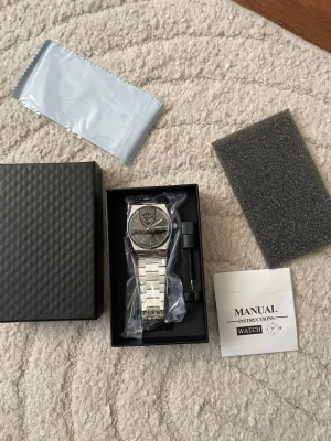 Poedagar Luxury Mens Watch - 🚚📦💨Ultra-Fast shipping!  Brand new Poedagar Watch. Black Dial, silver watchband. Adjustable size on the watchband.  Package Included: 1 x POEDAGAR Clock 1 x POEDAGAR Box 1 x Watchband adjust tool 1 x Watch wipe 1 x Manual Instructions 1 x Watch Battery  Enjoy luxury for a cheap price!💫  Additional Information:  Case Thickness: 11mm Band Width: 26mm Band Material Type: Stainless Steel Case Shape: Round Dial Window Material Type: Hardlex Boxes & Cases Material: Paper Dial Diameter