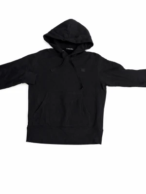 Svart hoodie från Acne Studios - Snygg svart hoodie från Acne Studios med klassisk huva . Tillverkad i mjuk bomull och har en stor magficka framtill samt Acne Studios logopatch på bröstet. Perfekt för en avslappnad och stilren look.