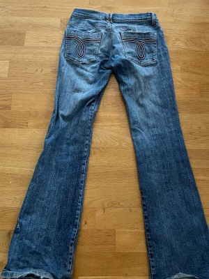 Lågmidjade jeans  - Så snygga lågmidjade jeans med detaljer på fickorna. Storlek S,  normala i storleken, men sitter snyggt även på storlek xs (blir lite mer baggy bara). Säljer då de inte passar längre, men är mina favoritjeans! 💙💙💙De har lite slitningar nere, och en av skärpöglorna på sidan är av. Jag tycker dock typ slitningarna gör jeansen ännu snyggare , och i övrigt är dem i jättebra skick!