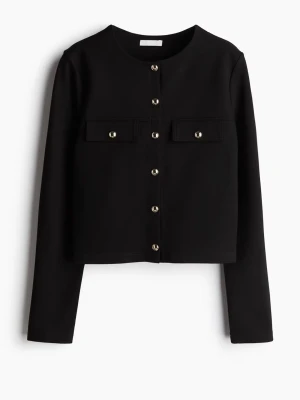 Svart kofta med guldfärgade knappar H&M - Stilren svart kofta från H&M med rund halsringning och långa ärmar. Koftan har dekorativa guldfärgade knappar framtill. Kortare modell som passar perfekt till både jeans och kjol.