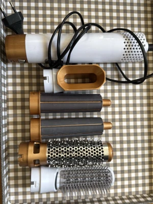 Multistyler för hår i vitt och guld - Säljer en multistyler för hår med flera utbytbara tillbehör, inklusive rundborste, volymmunstycke och två locktillbehör. Köptes för 600, oklart vart jag köpte den ifrån då det var längesen. Vit och guld med detaljer i grått. Perfekt för att skapa olika frisyrer och stylingar hemma. Elektrisk med sladd. Har använt en endaste gång på min bästavän. 