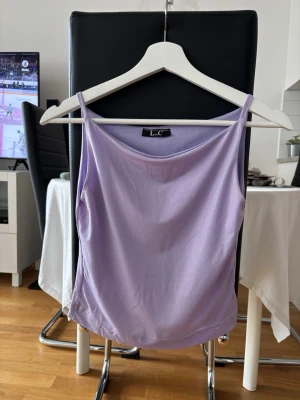 Ljuslila linnetopp från L.C - Säljer en ljuslila linnetopp från L.C med tunna axelband och enkel, stilren design. Toppen är ärmlös och har en mjuk, flowy passform som känns riktigt fräsch till sommaren. Perfekt att matcha med jeans eller kjol för en chill look.