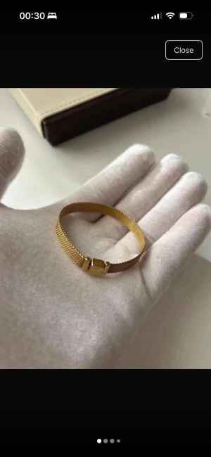 Pandora Guldigt mesharmband i metal - Stilrent armband i guldtonad metall med meshdesign och enkel låsdetalj. Armbandet har en modern och minimalistisk look som passar perfekt till olika outfits. Ingen synlig branding på armbandet.