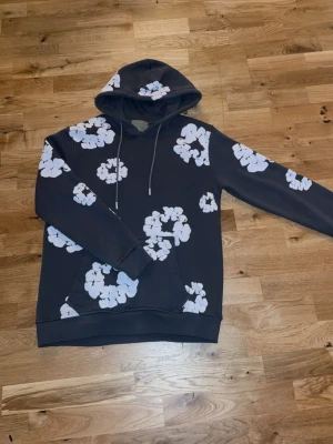 Mörkgrå denim tears hoodie  - Säljer en mörkgrå denim tears hoodie. Fick den i julklapp men har växt ur den. Mycket bra skick. Storlek M och finns i Halmstad men kan även skickas. (Äkta)