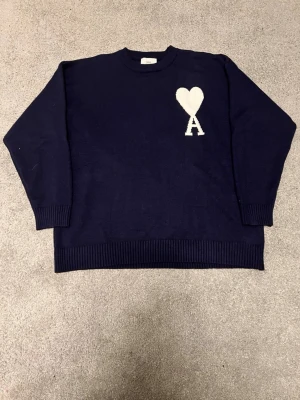 Mörkblå stickad tröja Ami Paris - Mörkblå stickad tröja från Ami Paris, passar något mindre, knappt använd 
