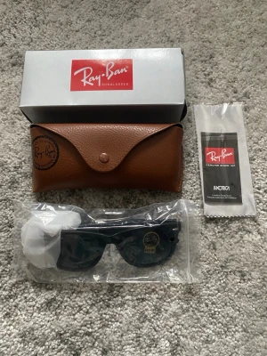 Ray-Ban Solglasögon  - Ett par svarta Ray-Ban solglasögon i nytt skick, oanvända. Orginalförpackning, etui med mera medföljer självklart (se bild 5). Hör gärna av er om det är nåt ni undrar!