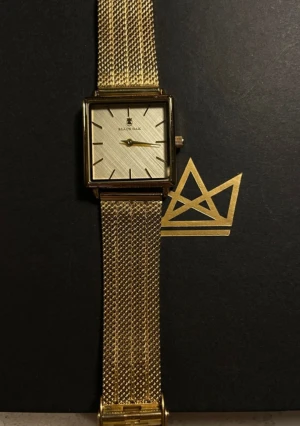 Guldfärgad klocka från Black Oak - Stilren klocka från Black Oak med fyrkantig urtavla och mesh-armband i guldfärg. Urtavlan är ljus med minimalistiska svarta markeringar och matchande guldfärgade visare. Fin och elegant klocka 💕
