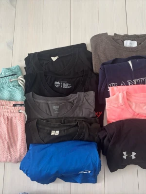 Klädpaket fynd - Fynd klädpaket  Badbyxor, Stickat, T-shirts, Pikétröja Träningsshorts,   Diverse märken #Under Armour, Bäck, Bullpadel, Black Crowe, Arket mm