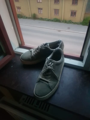 Gråa sneakers med vit sula - Säljer ett par Vagabond  stilrena gråa sneakers med vit sula och klassisk snörning. Skorna har en låg profil och är tillverkade i tygmaterial, vilket gör dem lätta och bekväma. Perfekta för dig som gillar en enkel och clean look till vardagsoutfiten och perfekt nu till hösten och sommaren. 