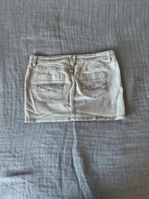 Grå lågmidjad jeanskjol - Jätte snygg lågmidjad jeanskjol från esprit i grått. Skön passform och perfekt längd!