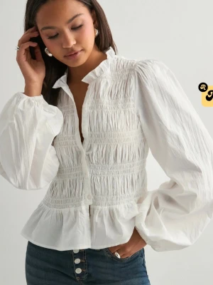 Vit blus med volang och puffärm - Superfin vit blus med smockad överdel, volangkant nedtill och stora puffiga långärmar. Blusen har en liten ståkrage och knäppning framtill. Perfekt för en trendig och chic look. ALDRIG ANVÄND LAPPARNA KVAR FRÅN NELLY