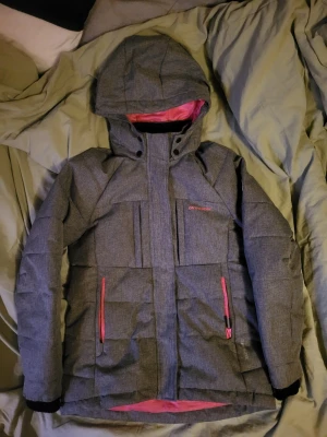 Skijacket  - An On the peak ski jacket for kids, with pink lining. Has never been used. It has a detachable hood and it is easy to take of and put on again. Wery comfortable and will keep you warm during the winter