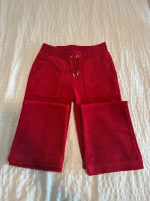  Juicy Couture byxor - Snygga helt nya aldrig använda röda mjukisbyxor från Juicy Couture i mjuk velour. storlek xxs men passar som xs-s.. Perfekta för en chill och trendig look. 