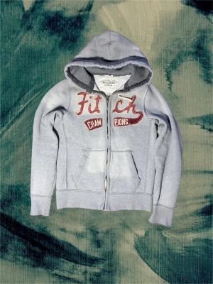 Grå hoodie från Abercrombie & Fitch - Tjena, säljer denna extreeemt feta och sällsynta hoodien från Abercrombie. Sjukt feta blekningar på ställena ni ser på bilderna! Passar dig mellan 180-188 och har mellan M-L. Denna passar extremt bra året runt och kommer garanterat få komplimanger. Hör av dig 👋