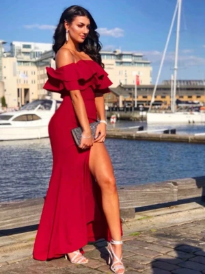 Vinröd offshoulder långklänning - Snygg vinröd långklänning med offshoulder och volangdetaljer upptill man kan ha på balem/ bröllop . Klänningen har en  slits på ena sidan och figurnära passform. Perfekt för bal eller fest. Storlek 6 motsvarar S