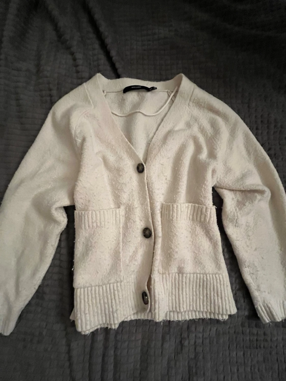 Vit kofta med knappar och fickor