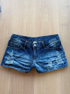 Blå denimshorts med broderad ficka - Säljer dessa snygga shorts då dom tyvärr inte passar längre använts få tal gånger och i väldigt bra skick! Storlek M men skulle säga S-M. 