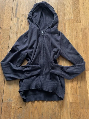 Svart/brun/grå hoodie med dragkedja från 157 - Svart hoodie från 157 i storlek XS. Modellen har dragkedja framtill, huva med dragsko och breda ribbade muddar vid ärmslut och nederkant. Perfekt för en avslappnad och stilren look. Passar till det mesta 😋