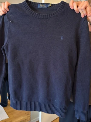 Mörkblå stickad tröja Polo Ralph Lauren - Klassisk mörkblå stickad tröja från Polo Ralph Lauren st L. I nästan nytt skick bara använts några få gånger
