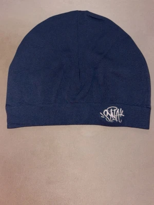 Syna world mörkblå - Säljer en ny syna world skullcap som är färgen märkblå