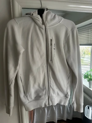 Vit hoodie från Sail Racing XS - Säljer nu min Sail Racing huvtröja i strl XS. Säljer den pga att jag inte använder den längre. Tröjan är köpt här på Plick och har ett hål på utsidan (se bild) som jag sytt igen som kommer från den tidigare säljaren. Men ingenting som syns, fint skick annars och inte använd många gånger!