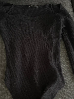 Svart ribbad topp - Säljer en svart långärmad body topp från SHEIN med ribbad struktur och fyrkantig urringning. 