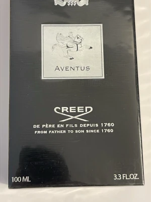 Creed Aventus Eau de Parfum 100ml - Creed Aventus Eau de Parfum är en exklusiv parfym i svart och silver förpackning. Flaskan rymmer 100 ml och har en elegant design med klassiska detaljer och logotyp. Aventus är känd för sin lyxiga och tidlösa doft, perfekt för dig som vill sticka ut.