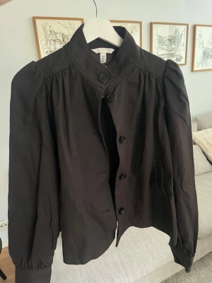 Twilljacka med puffärm brun  - Säljer denna populära jacka från H&M i mörkbrunt. Väldigt fin och trendig modell med puffärm och lösare ärmar. Jackan är helt slutsåld online och svår att få tag på. Passar perfekt till både vardag och finare tillfällen.  Aldrig använd, och prislappen sitter kvar säljer pga köpte två olika storlekar🤍