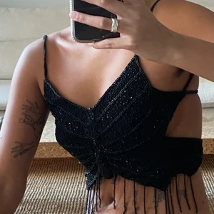 Butterfly-topp  - Galet fin svart butterfly-topp á Mariah Carey år 2000. Öppen rygg som man knyter själv så den kan anpassas efter personen som bär den. 