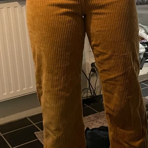 manchesterbyxor - Ett par manchesterbyxor i en ljus brun/gul färg, dom är tajta uppe vid låren men blir sen wide efter knäna.