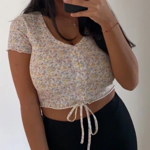 Topp - Blommig topp med snören. Strl 34/36. Pris 50kr