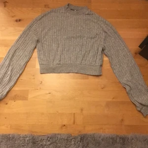 Grå tröja  - En tröja som går upp lite i halsen.Skön att ha över ett linne osv.Den hära tröjan har aldrig kommit till andvändning.Väldigt skön och gosig.