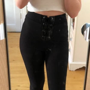 Svarta byxor - Svarta byxor/tights i ett ish ribbat material med cool snörning framtill. Hög midjade och rätt stretchiga!