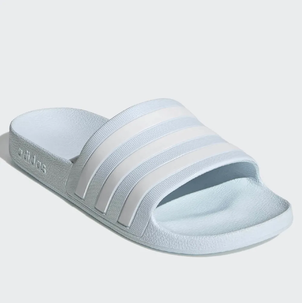 Helt oanvända adidas tofflor i färgen blå säljes pga fel storlek. Skor.