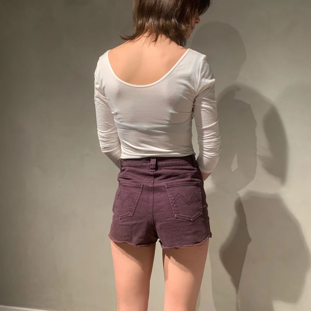 Jeans shorts from Mink Pink. Distressed cotton in an aubergine dark purple. XS Model is 167cm and wears a 24-25 in most jeans brands.. Shorts.