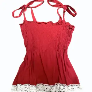 gulligt rött linne som är perfekt för sommaren ☀️ banden knyts med rosetter och linnet svängs ut ❤️ 