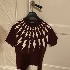 Neil Barret T-shirt - En extremt ovanlig T-shirt som är jävligt fet och unik. Säljer T-shirten då den är lite liten och har varigt sen jag köpte. T-shirten har inga deffekter och skicket är 10/10. Ny pris 4100 vårt pris 890. 