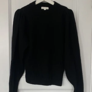 Stickad tröja - En jättefin stickad svart tröja från HM. Det är lite svårt att se på bilden men den har lite puff i axlarna🥰 Den är endast använd ett fåtal gånger, alltså i jättefint skick 🤍 storleken är XS men passar även S! 