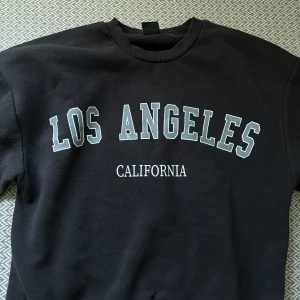 Sweatshirt med tryck - En sweatshirt med tryck ifrån ginatricot. Knappt använd och inga defekter. Den är i en jätte fin mörkgrå färg, säljer för 79kr.