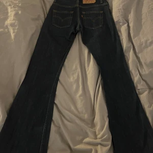 Levis jeans - Säljer dessa jättefina utvängda mörkblå jeans med bra kvalitet från levi’s! Då de tyvärr har blivit för små för mig🌸 Innerbens mått: ca 82cm  Midjan runt om: ca 71cm  Bara att höra av sig vid intresse och frågor!🥰